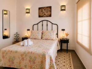 a bedroom with a bed with two towels on it at Hostal El Faro in Chipiona +65 photos