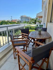 a patio with tables and chairs on a balcony at Holiday Nest & parking in Ialysos