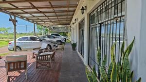 a porch with benches and cars parked on it at La Liebre in Federación