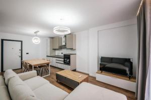 a living room with a couch and a table at Cuni Luxury Hotel in Sarandë