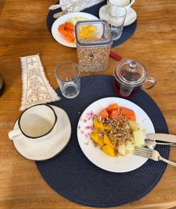 a table with plates of food on a table at Pousada & Hostel América in Barreirinhas