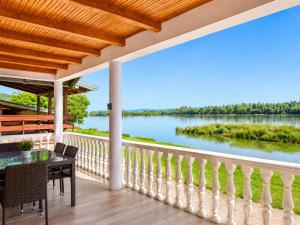 a balcony with a view of the water at Danube Panorama House - River View, Jacuzzi & Nature in Čelarevo