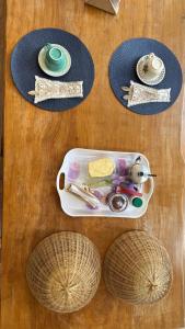 a table with a tray of utensils and plates at Pousada & Hostel América in Barreirinhas