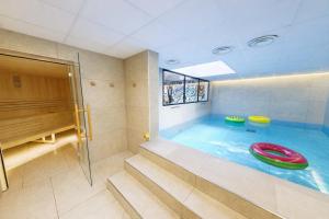 a swimming pool with a red frisbee in it at Hife Paris Issy Porte de Versailles in Issy-les-Moulineaux