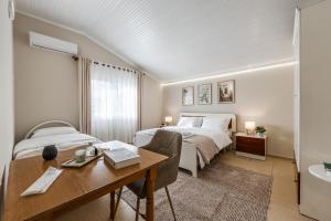 a bedroom with a bed and a desk and a bed and a sink at Loen Spacious Seaside Apartment 3BR Free Parking by PikHost in Durrës