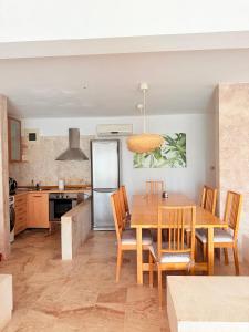 a kitchen with a table and chairs and a refrigerator at Afremar Estate in Nea Fokea