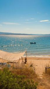 a boat in the water on a beach at Afremar Estate in Nea Fokea