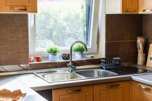a kitchen with a sink and a window at Loen Spacious Seaside Apartment 3BR Free Parking by PikHost in Durrës