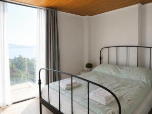 a bedroom with a bed and a large window at Afremar Estate in Nea Fokea