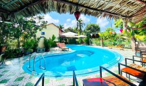 a large swimming pool in a yard at Tam Coc Riverside Bungalow in Ninh Binh