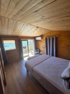 a bedroom with a large bed in a room with wooden ceilings at Les Restanques de Camélie in Saint-Thomé +33 photos