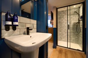 a bathroom with a sink and a shower at Plockton Inn, by Highland Coast Hotels in Plockton