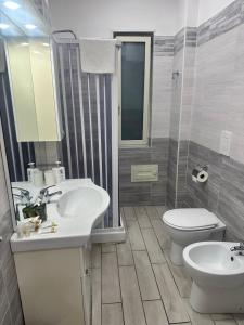 a bathroom with a sink and a toilet at Solforia Holiday House in Pozzuoli