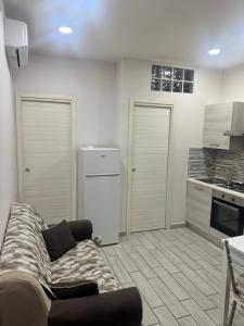a living room with a couch and a kitchen at Solforia Holiday House in Pozzuoli +8 photos