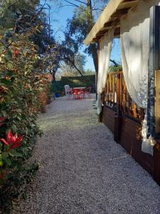 a patio of a house with a table and chairs at Mobil Home Sainte Baume 6 personnes in Nans-les-Pins
