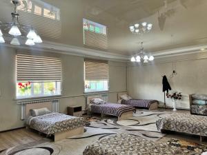 a living room with two beds and a large rug at Apartmenthouse in Naryn