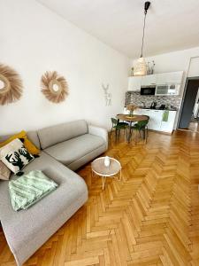 a living room with a couch and a table at Bright and central suite with a balcony in Brno