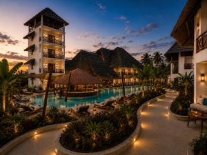 a resort with a swimming pool and a building at Faro Resort in Nungwi