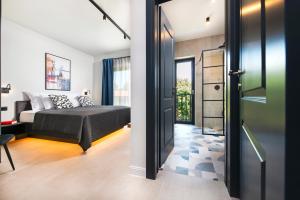 a bedroom with a bed and a door leading to a balcony at Ombra in Bale +49 photos
