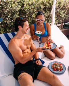 a man and a woman sitting on a table with a plate of food at InterContinental Malta by IHG in St. Julianʼs +277 photos