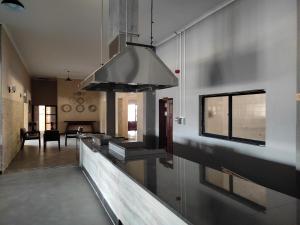 a kitchen with a sink and a stove at GreenLand Hotel in Kasane