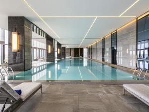 a swimming pool in a building at Pullman Jiaxing Pinghu Excellence in Jiaxing