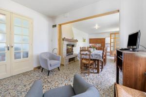 a living room with a table and a dining room at Gîte Chez Madeleine in Coutances