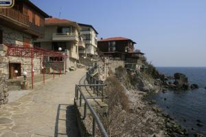 a street with houses on the side of a cliff at Guestrooms Durna in Sozopol