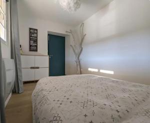 a bedroom with a bed and a tree in it at Dépendance au goût de vacances in Moulainville-la-Basse +6 photos