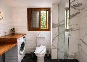 a bathroom with a toilet and a glass shower at Casablanca Villa by HolidayKeys in Kyrenia +14 photos
