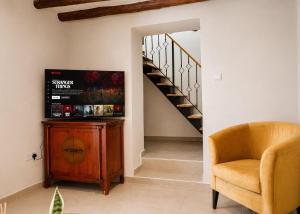 a stairway with a chair and a wooden cabinet at Casablanca Villa by HolidayKeys in Kyrenia