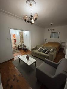 a living room with a couch and a bed at Quartos Confortáveis em Belo Horizonte in Belo Horizonte +8 photos