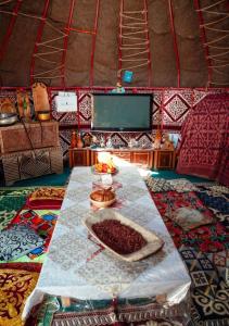 a table in a yurt with a bowl of beans at Юрта в аренду in Almaty