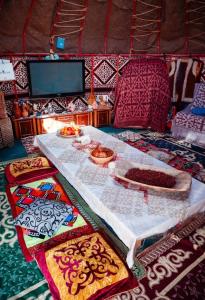 a table in a yurt with food on it at Юрта в аренду in Almaty