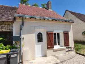a small white house with a white door at La Maisonnette Montlouisienne in Montlouis-sur-Loire