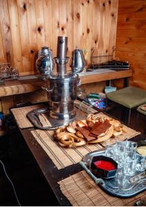 a table with a mixer and a plate of food at Юрта в аренду in Almaty