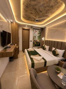 a hotel room with a large bed and a desk at Hotel Premium Suites-Free Airport Pickup in New Delhi