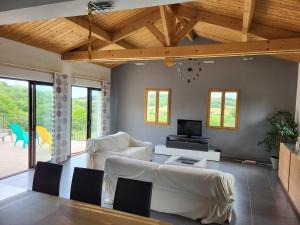 a living room with white furniture and wooden ceilings at Belle Villa 160 in Blars