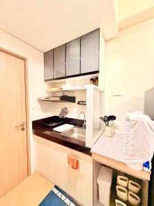a kitchen with a sink and a counter top at Hope Residences by YsaRiCh Haven in Trece Martires