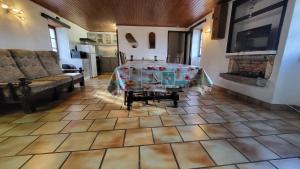 a living room with a table on a tiled floor at Coeur De Causse in Blars +8 photos
