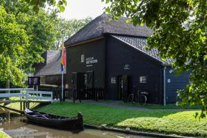 a black building with a gondola in front of it at OV815- Chalet Eveline in Blokzijl