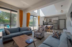 a living room with a couch and a table at Villa Sasadi in Fethiye
