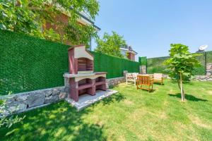 a backyard with a bench and a fence at Villa Sasadi in Fethiye