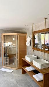 a bathroom with two sinks and a bed with mirrors at Domaine Coul'Eau in Eaunes +48 photos