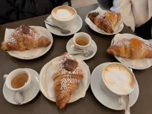 a table with plates of pastries and cups of coffee at Il Palazzetto in Gaeta