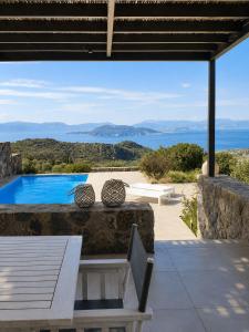 a villa with a view of the ocean at Óros Residence - Pool & Panoramic Views in Tzíkidhes