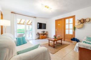 a living room with a couch and a tv at Can Freixa - Sóller in Sóller