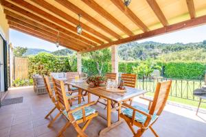 a dining room with a wooden table and chairs at Can Freixa - Sóller in Sóller