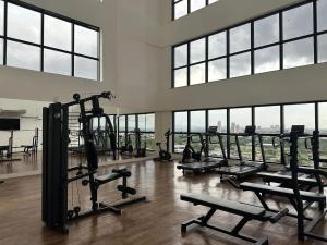 a gym with treadmills and machines in a building at AliReserva Luxury Suites in Palmas