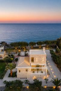 an aerial view of a house with the ocean in the background at Villa Pelagos in Koutsounari